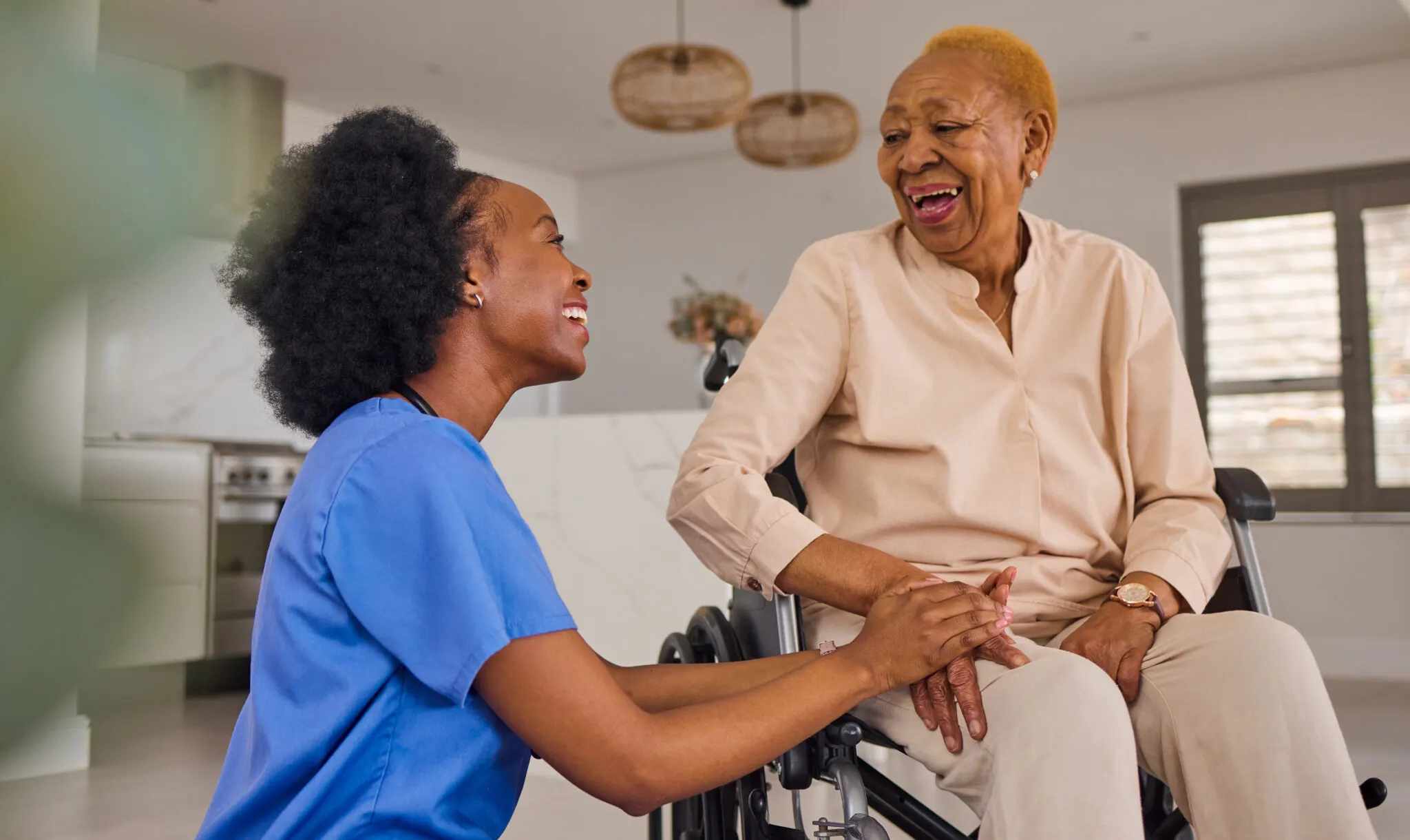 Elderly woman smiling with her caregiver